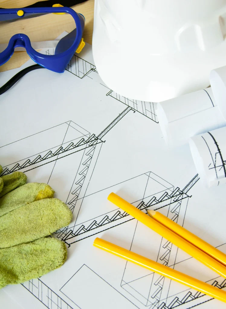 Construction drawings and PPE used for pre-construction planning and design coordination